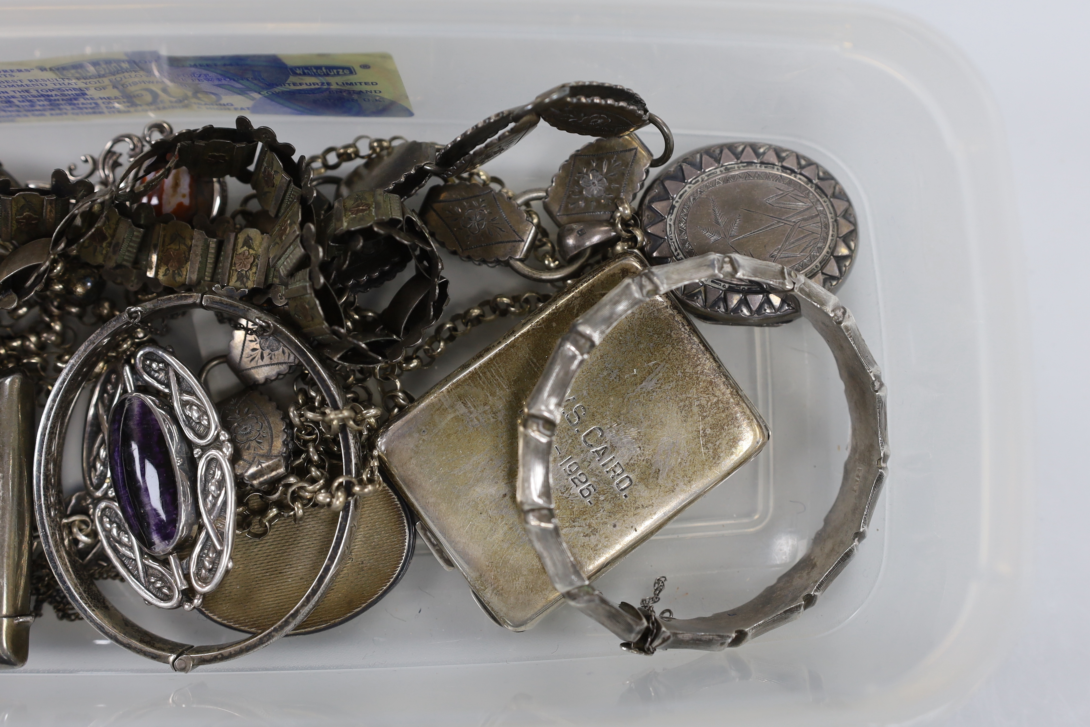 A Victorian silver oval locket, on a white and yellow metal chain, overall 52cm and other jewellery including silver and white metal lockets, vest case etc